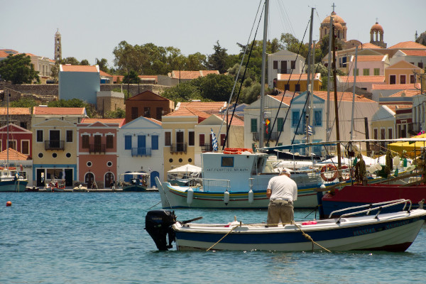 Some small boats in the port and a part of the settlement of Kastelorizo in the background.