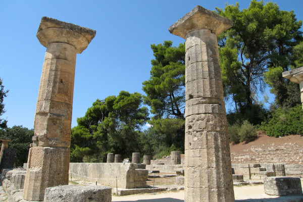 A picture showing two columns and other remains of the archaeological site of Ancient Olympia.