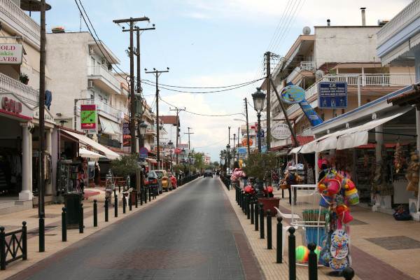 A central street of Paralia of Katerini with numerous shops on both sides.