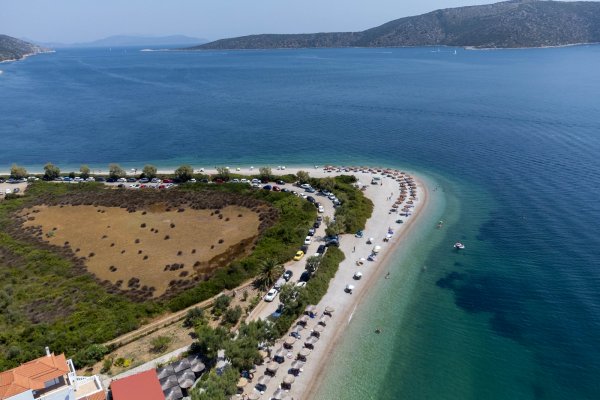 An aerial photo of the Agios Dimitrios beach on Alonnisos among different shades of blue.