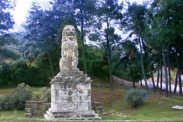 The marble statue of Amphipolis placed on a pedestal surrounded by trees.