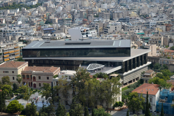 A view of the exterior of the Acropolis museum in Athens among hundreds of modern buildings.