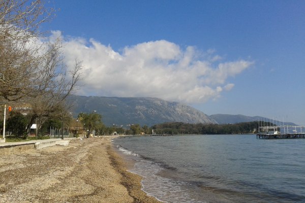 Pebble grounds and the sea and a floating pier at Dassia beach, Corfu,