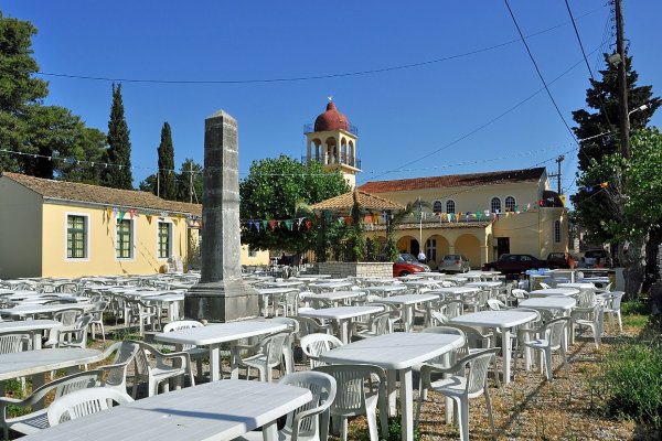 Gouvia's church yard is full of tables and chairs in preparation for the local festival.