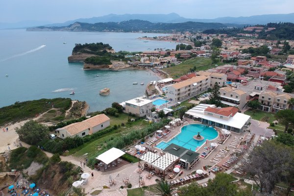 A pool bar and tourist resorts and three bays in the background at Sidari, Corfu.