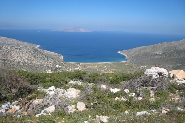 A panoramic picture of Agia Theodoti Beach on Ios island surrounded by barren rocky hills.