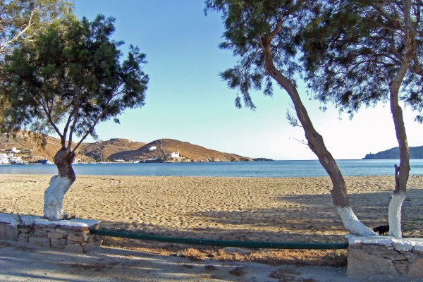 A part of the Gialos (Ormos) Beach at Chora of Ios in a picture between two trees.