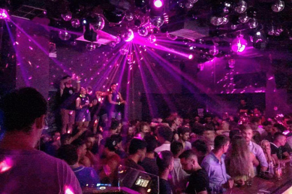 Inside one of the most popular nightclubs of Ios, Disco 69 where a purple beam lights up the place.