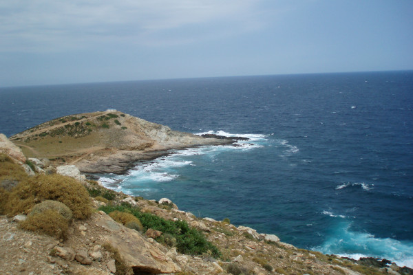 An overview of the Cape Cavo D'Oro with waves crashing on the shore.