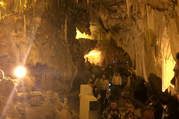 Visitors on a guided tour inside the Dragon's Cave of Kastoria.