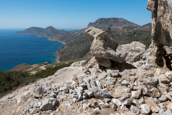 A pile of broken white rocks and a panoramic view over Kos' long landmass. 