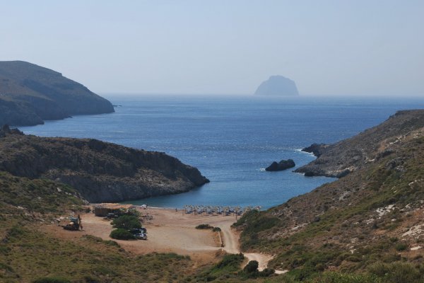 A picture of Melidoni Beach on the island of Kythira, and the wild-rock islet in the horizon.