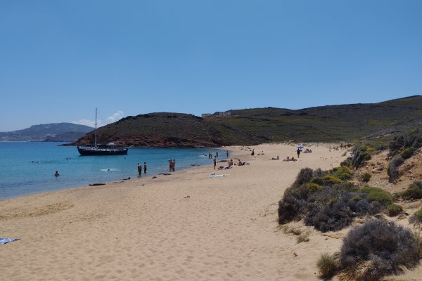 The Agios Sostis Beach and it's surrounding enviroment while a boat is anchored.