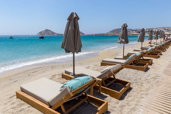 Turquoise waters and a line of loungers on Kalafati Beach, Mykonos.