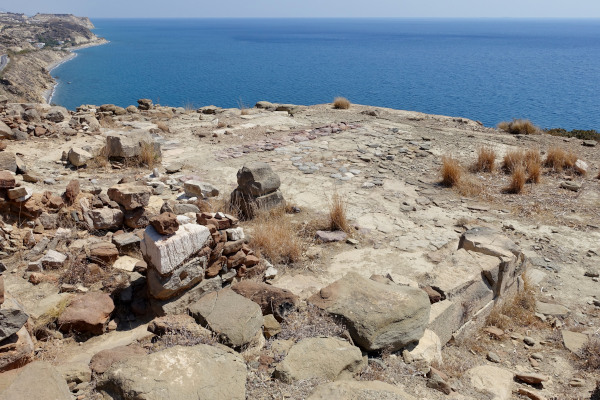 Remains of the Archaeological Site Pyrgos Myrtos with the blue sea in the background.