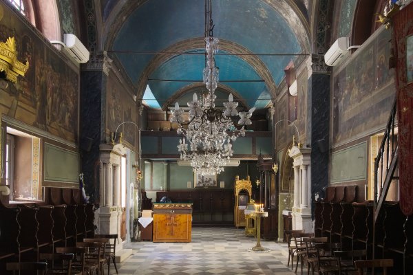 The interior of an arched church with blue ceiling and hagiography - Saint Spyridon Church, Nafplio.