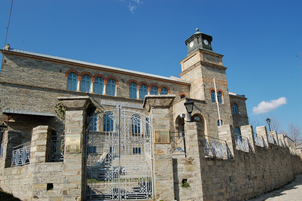 The stone-built fence and the exterior of the building of Nikios Scholi in Nymfaio.