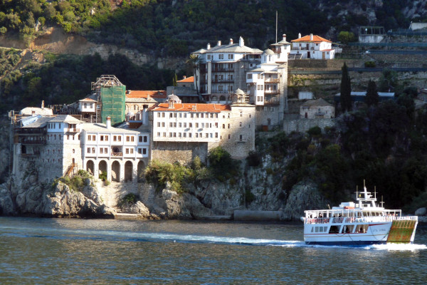 A picture shows the cruise tour boat with a monastery in the background.