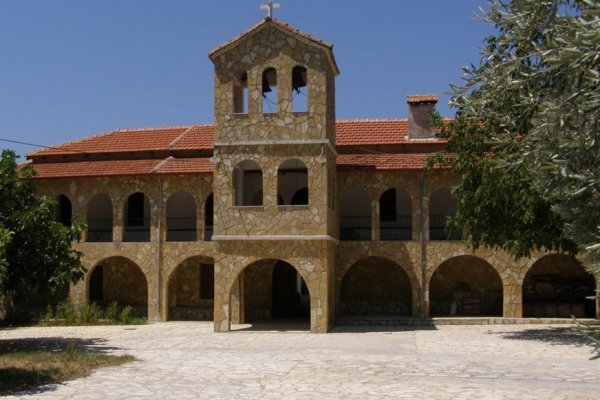 A picture of the Paganion Monastery at Paramythia Thesprotia with brown stone and many arches.