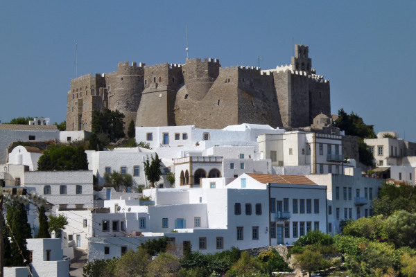 A picture showing the walls of the Monastery of Saint John the Theologian over the buildings of Chora on Patmos.