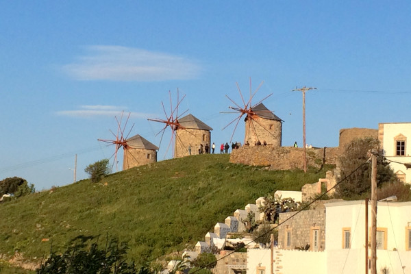 An image showing the three windmills of Patmos on a green hill.