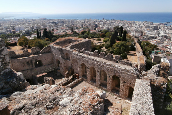 An overview of the remains of the Patras castle with the view of the city and the sea in the background.