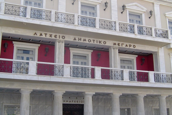 The Latseio Town Hall of Pyrgos is a three-story neoclassical building with white columns.