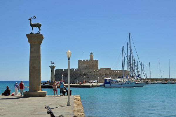 The entrance of the Mandraki Port of Rhodes island with two deer statues on columns.