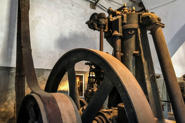 An image showing an old engine in the Tomato Industrial Museum of Santorini.