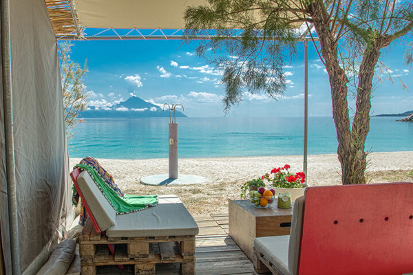 A photo taken from one of the Bungalows of Armenistis Camping with the great view of the beach and the Mount Athos.