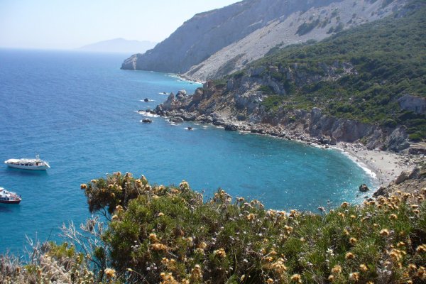 Two boats anchored in the bay of Kastro, Skiathos, where rock is the dominant element.