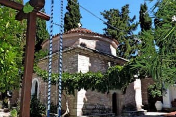 An old chapel made of stone surrounded by trees, St. Charalambos Monastery, Skiathos.