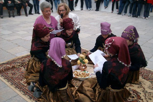 A photo of young women who take part in the custom of Koukouma on the island of Symi.