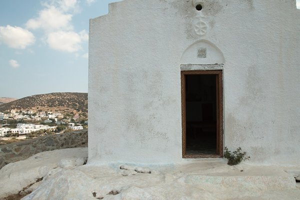The white walls of the Saint Pakou Chapel on the hill of Galissas and its open door.