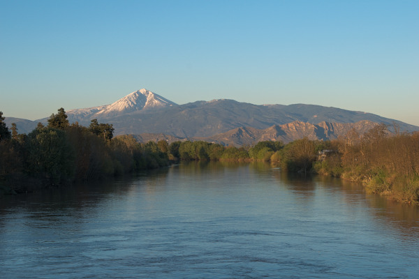 A picture taken from Pinios River with the snowy peak of Mount Ossa.