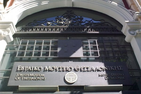 The entrance of the Jewish Museum of Thessaloniki in a neoclassical white arch.