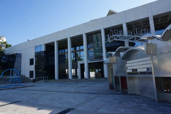 The Teloglion Fine Arts Foundation is a large white building with outdoor stairs leading to the upper floors.