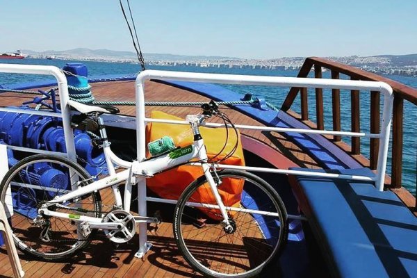 A bicycle tied on the deck of a ferry boat to Peraia & Neoi Epivates with wooden parts - some painted in blue.