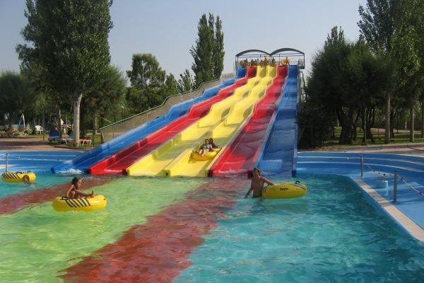 Children enjoy six colourful waterslides that lead into a pool.