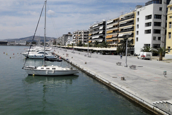 Sailing boats anchored by the wide seafront promenade of Volos.