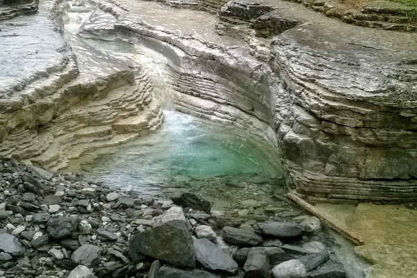 Water of the Rogkovo stream flowing through the rocks and the created the natural rock pool.