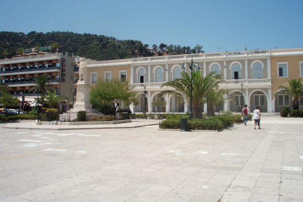 A photo of the Dionysios Solomos Square of Zakynthos Town where the statue of the poet and theater are visible.